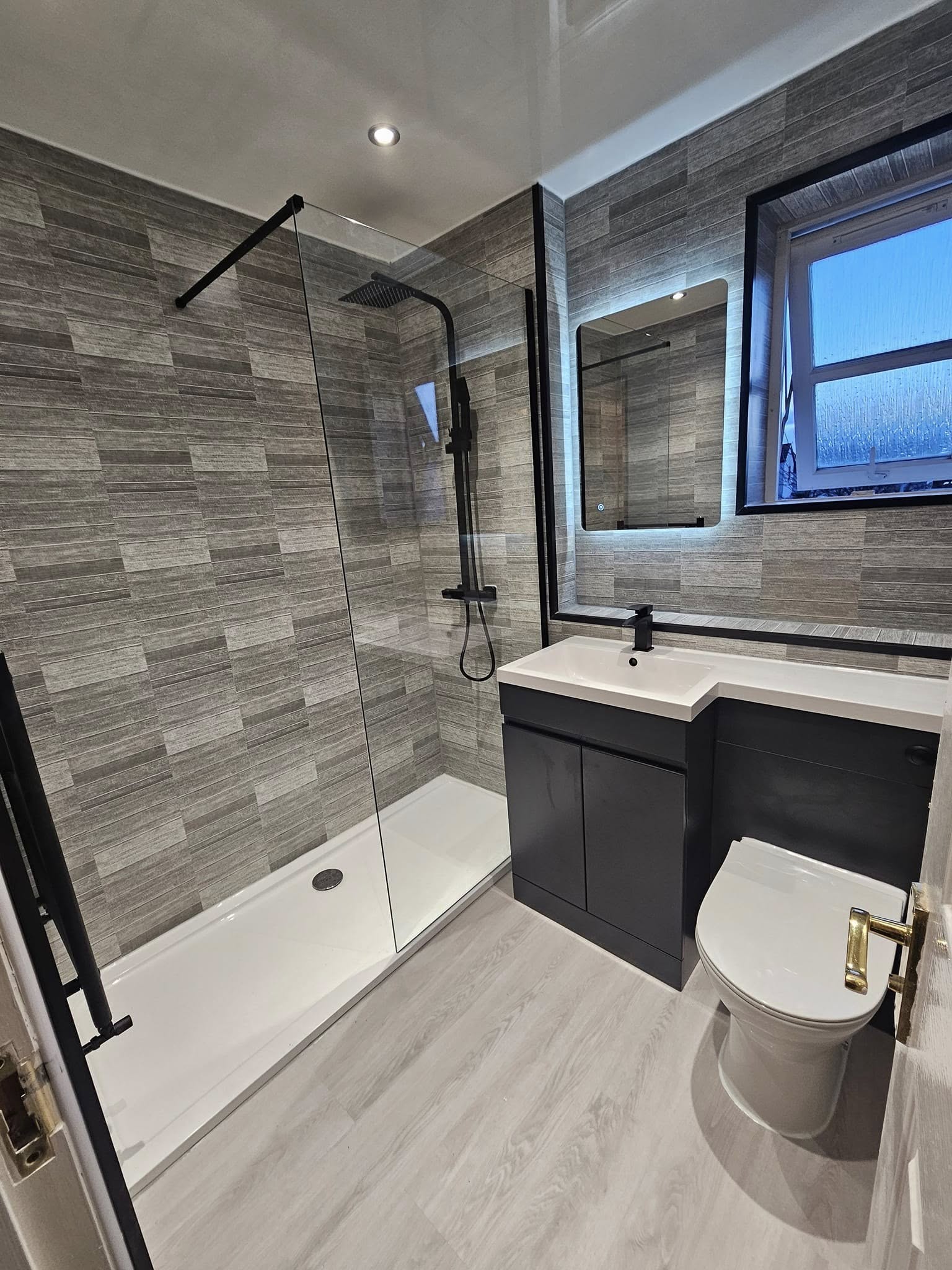 Grey tiled walk-in shower room