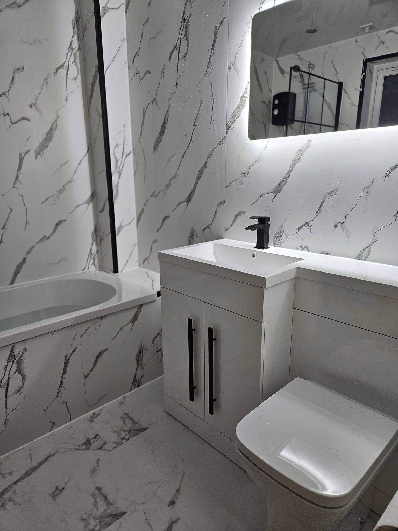 White vanity and marble bathroom